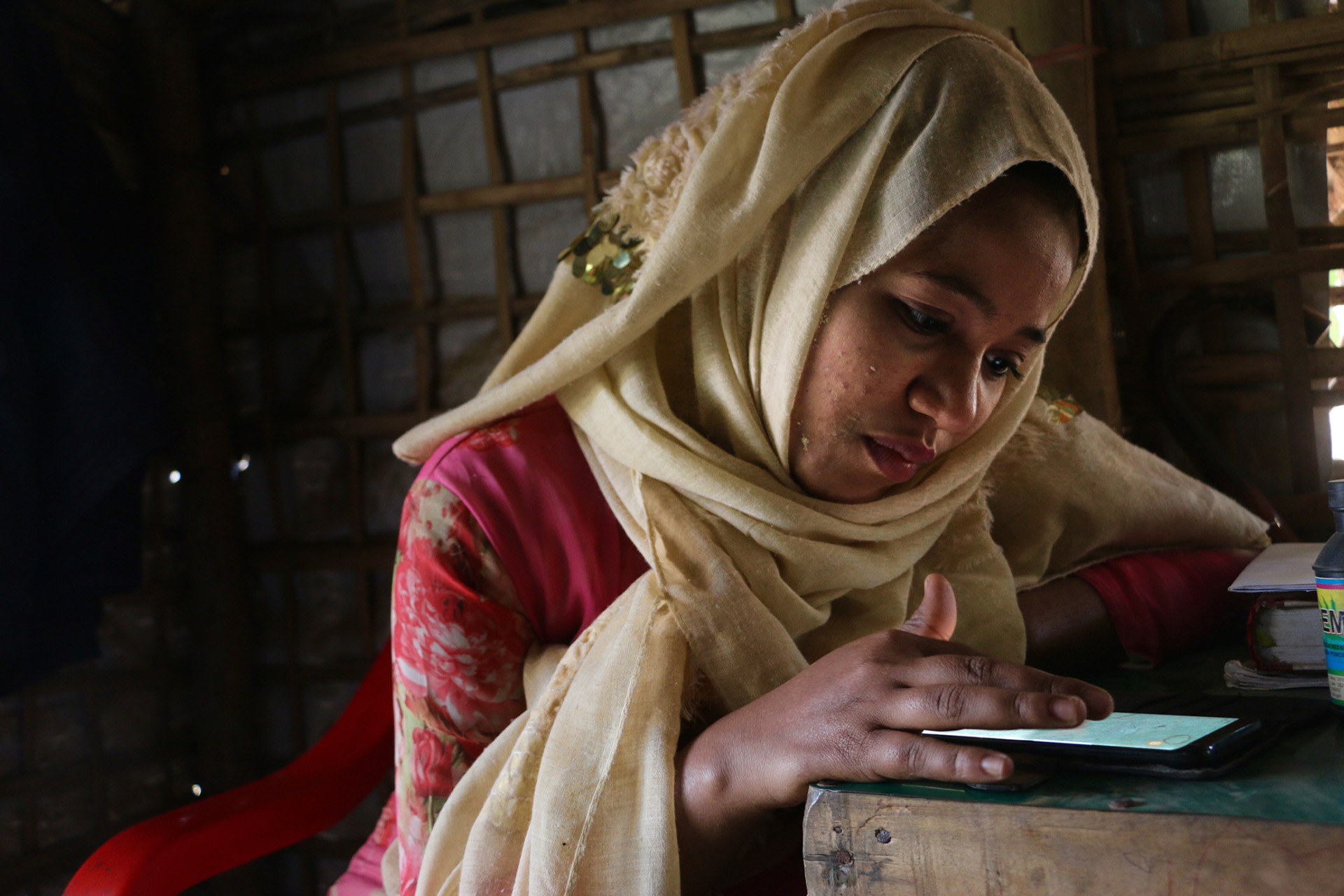 Image of Omal Khair on her phone