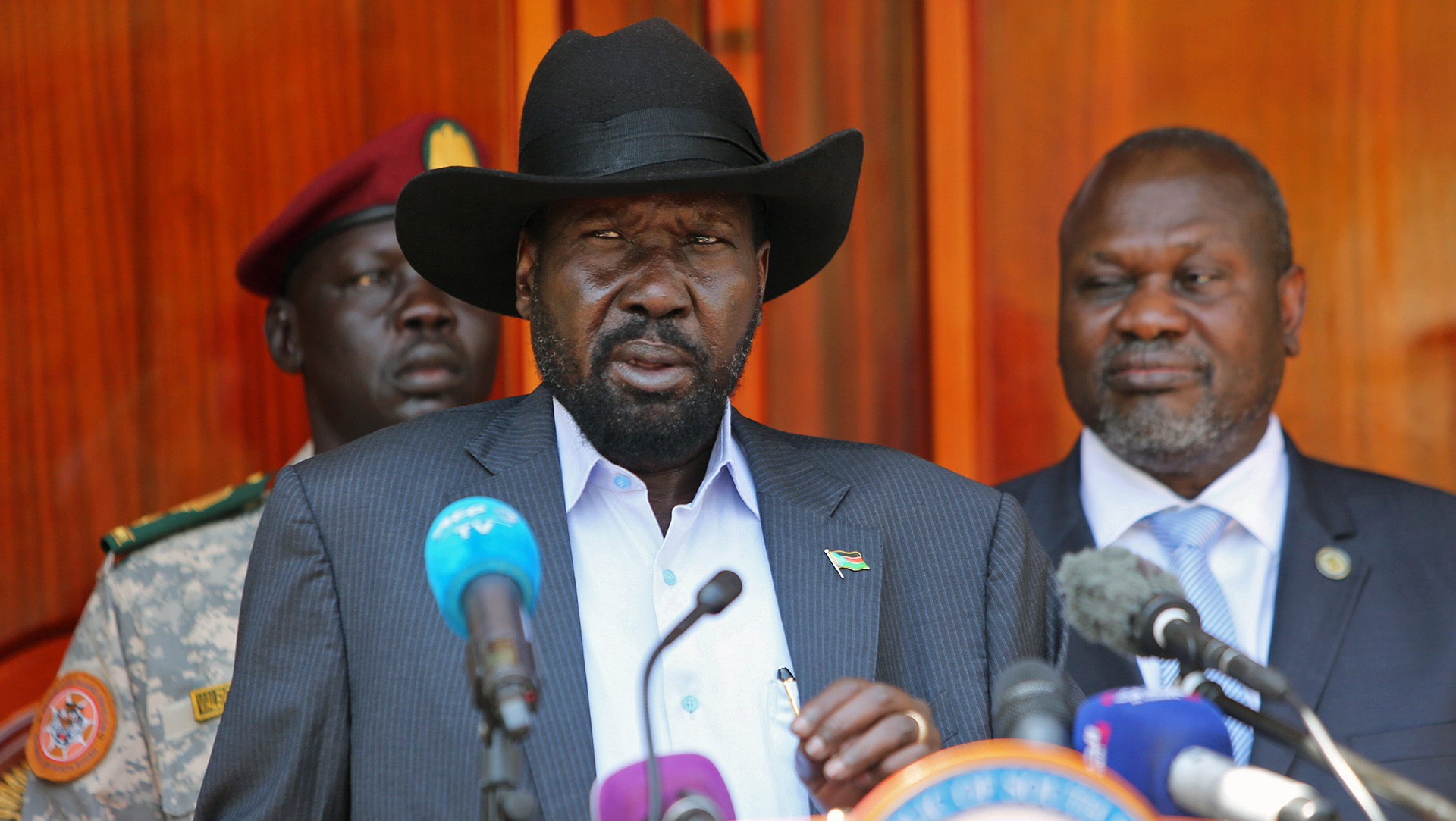 South Sudan's President Salva Kiir Mayardit speaks into a microphone behind a podium.