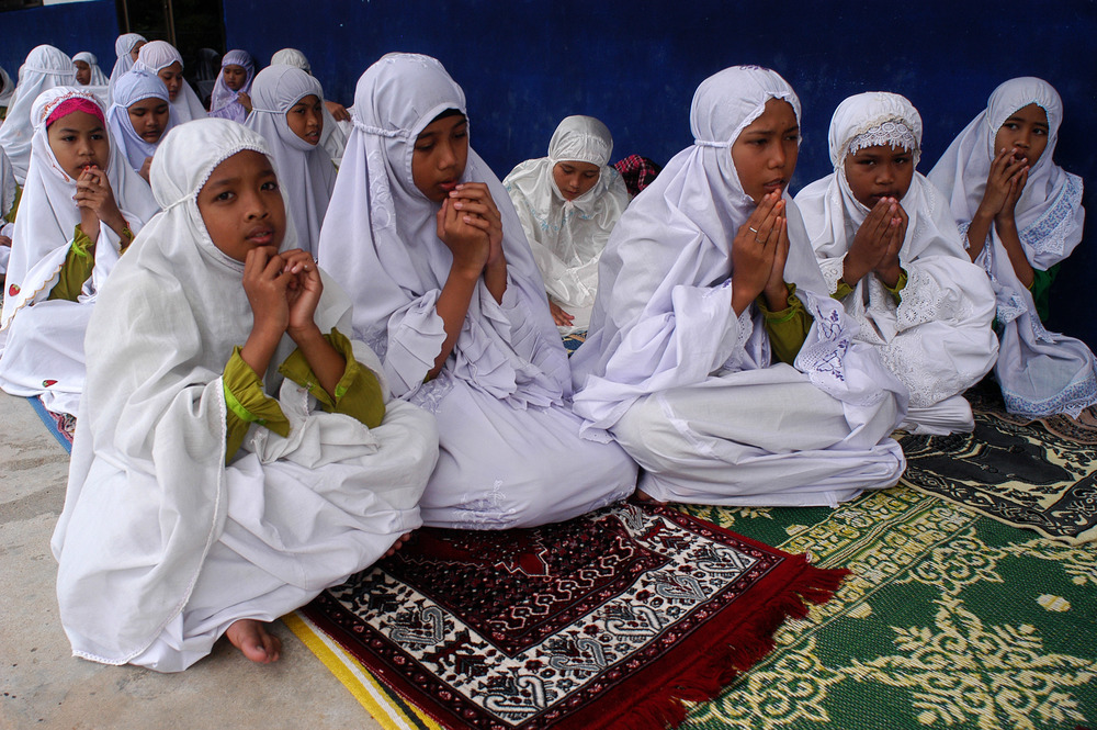 Female students from Ban Paku Village pray