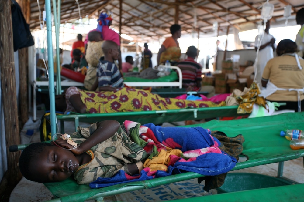 A child recovers from the journey and sleeps in the health clinic at Lake Tanganyika Stadium in Kigoma, Tanzania