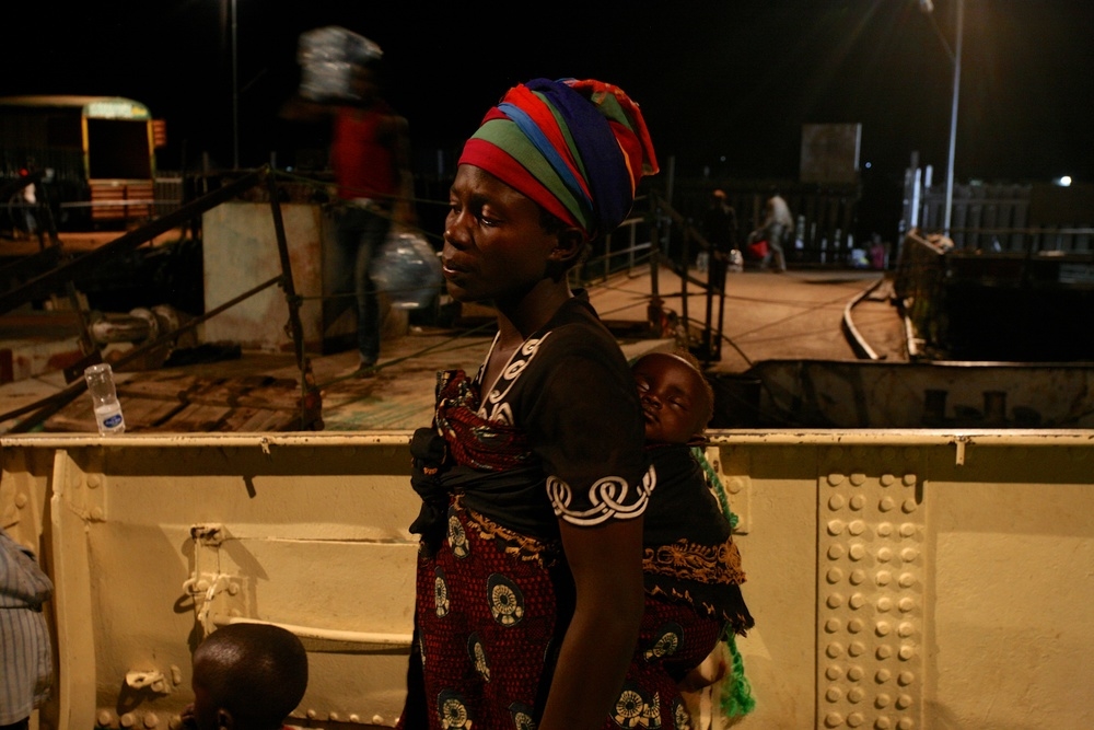 Delphin Nyiyanwi waits aboard the MV Liemba for the body of her 4-year old son to be carried off the boat after he died of suspected cholera. “