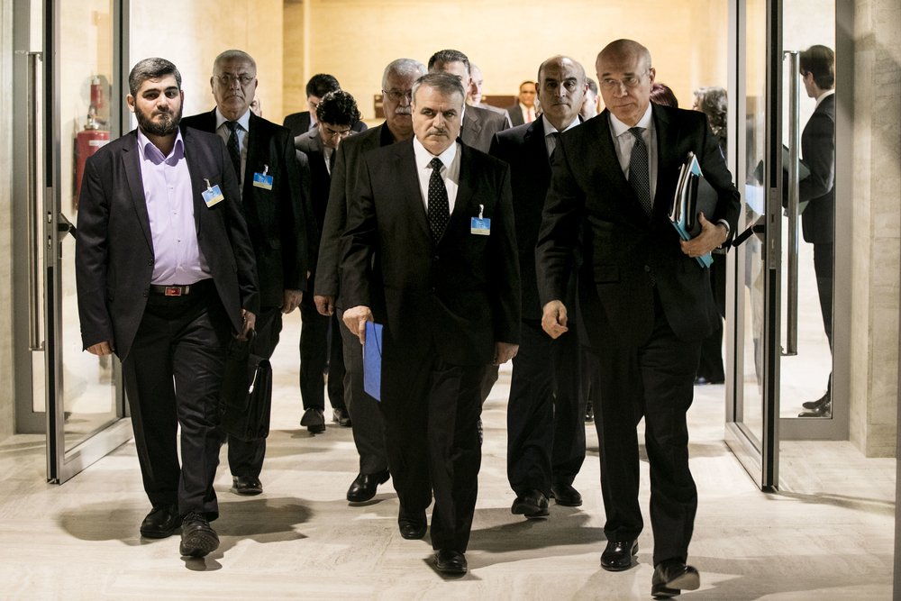 Group of men walk down a hallway