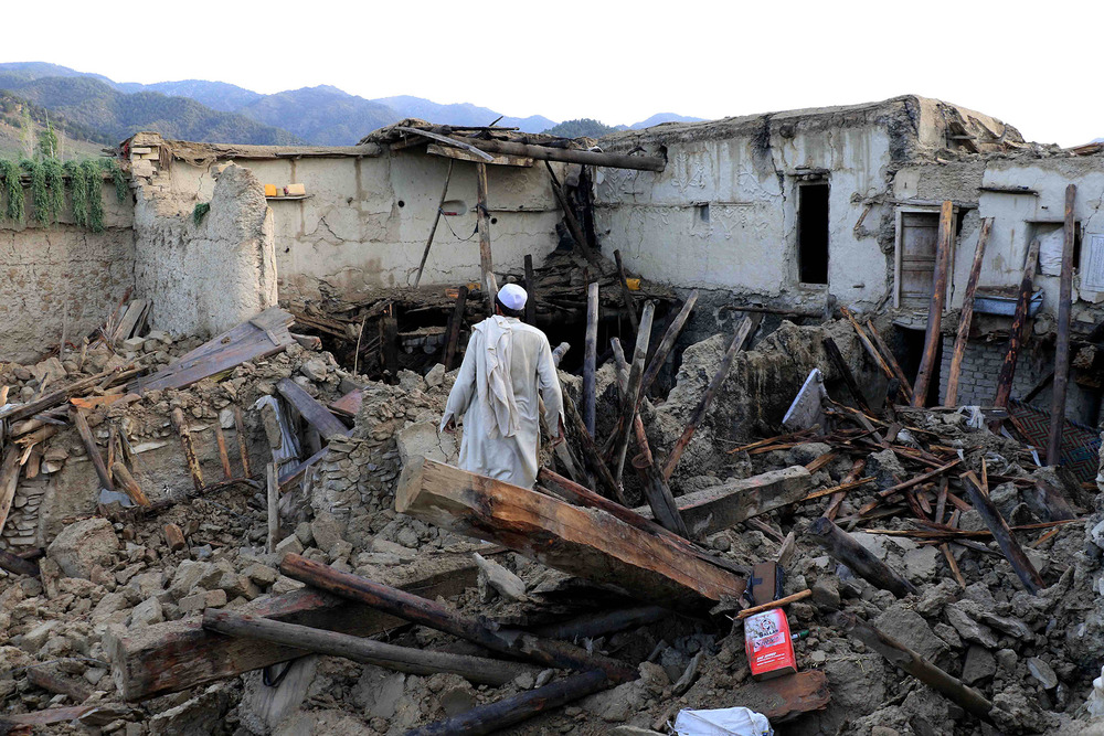 Aid has been slow to reach the remote areas worst hit by last month’s earthquake. Here, in Ochlakai village, a survivor assesses the damage to his home.