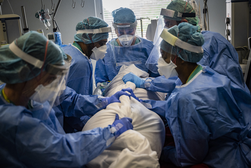 Doctors tend to a suspected COVID-19 patient at the Royal Free Hospital in London