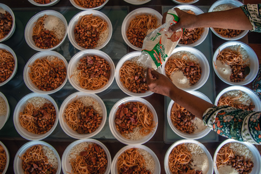 Meals are prepared by an informal community aid group in Salvador.