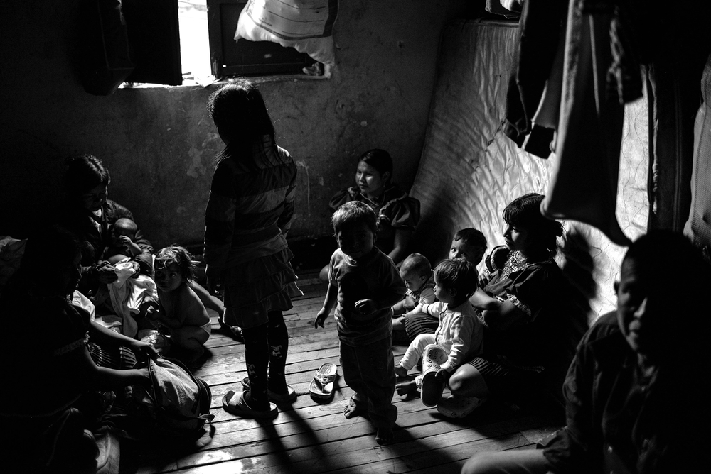 Several members of an Emberá family sleep in a small room of this guesthouse in San Bernardo, a rundown area in downtown Bogotá. Many indigenous families have spent years living in dire conditions after being forcibly displaced from their land.