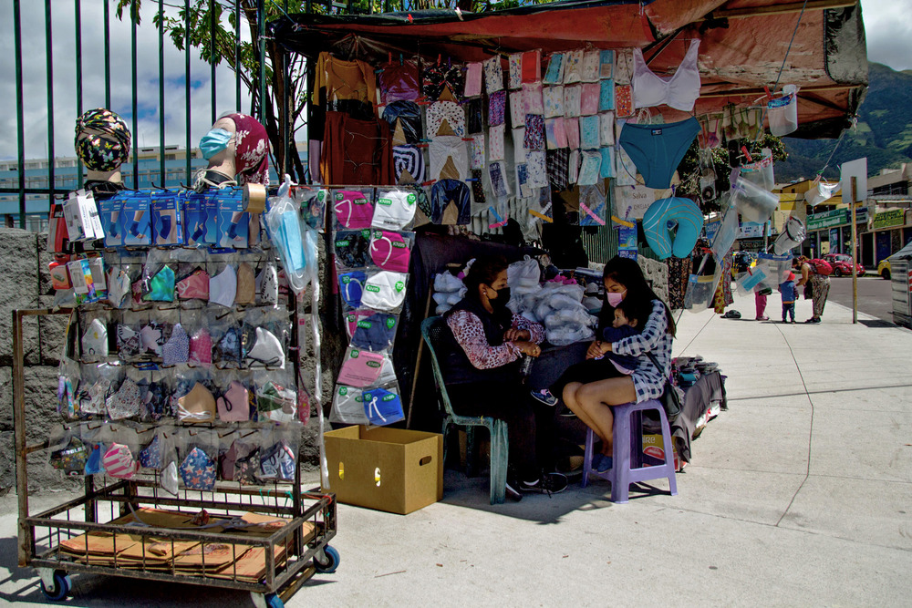 A street vendor sells masks and other basic supplies outside the Carlos Andrade Marín Hospital.