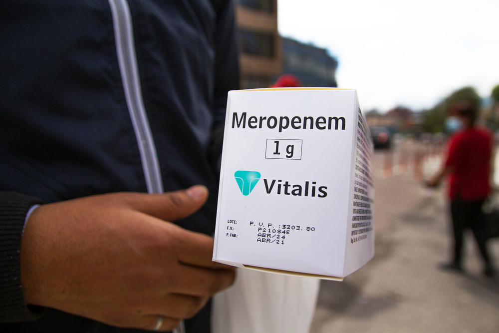 A delivery man brings a box of COVID-19 medication to the Carlos Andrade Marín Hospital in Quito, Ecuador. The hospital had ran out. The medication costs $300 – which the patient will have to pay themselves – and will likely only last three days.