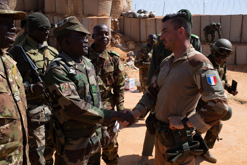 The commander of the G5 Sahel force at the time, General Namata from Niger, shakes the hand of a French soldier during his visit to the Boulkessi base in November 2019.