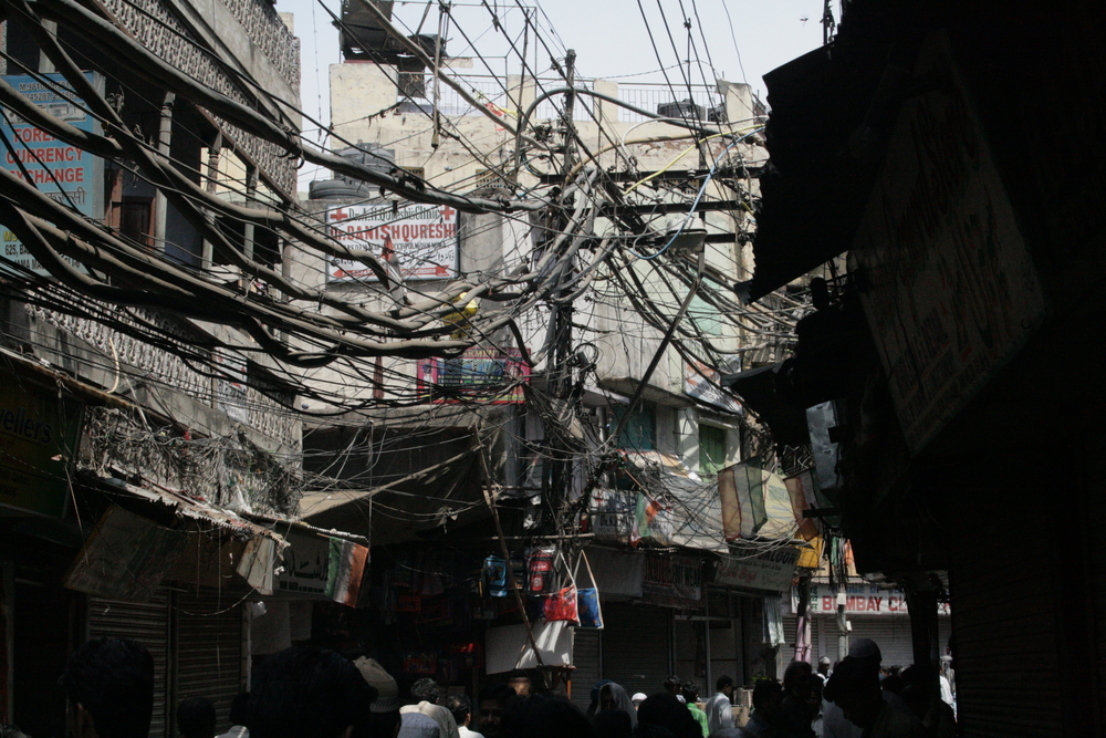 When infrastructure is not provided, or not affordable, the urban poor find their own way around the problem, as in Delhi, India, where electricity is tapped.