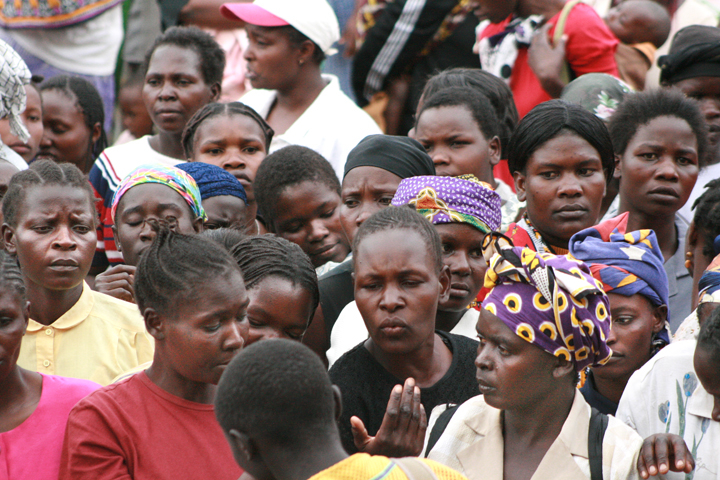 A group of displaced women gather to await distribution of clothes donated to them at the Nairobi Showground camp for the internally displaced on 13 February 2008.