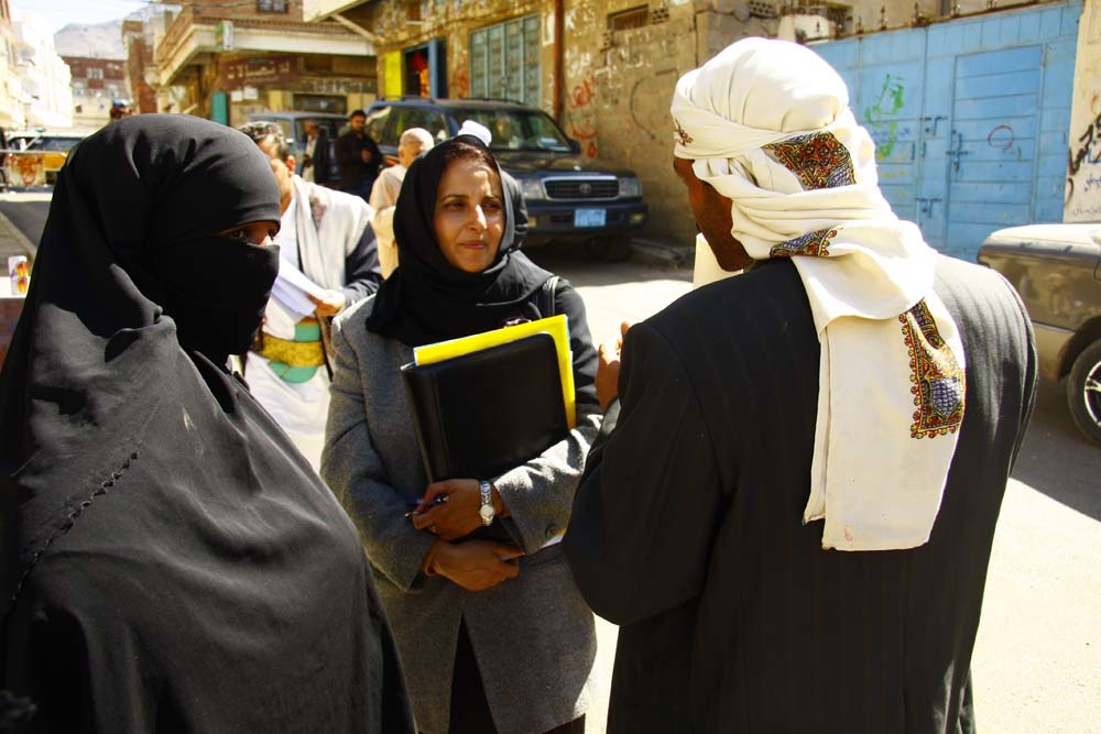 Shada Mohammed Nasser, a lawyer at the High Court in Sanaa, talking to the parents of a child bride outside court