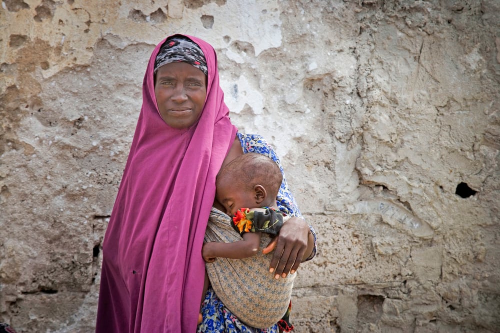 A mother and child wait to be seen at the Outpatients Department, AMISOM base in Mogadishu, Somalia