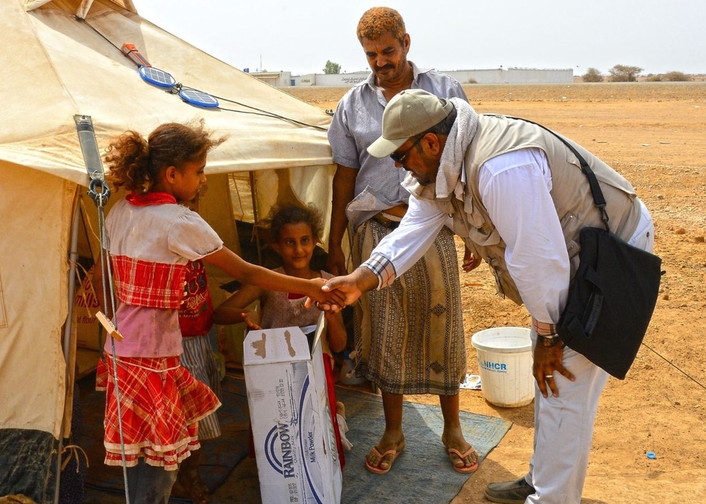 A photo released by the King Salman Center for Humanitarian Relief showing aid workers with displaced Yemenis in Djibouti