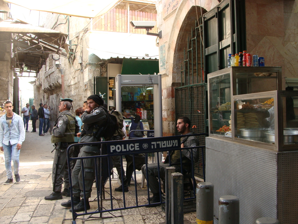 Israeli forces and a newly installed metal detector on the corner of Al Wad Street, in Jerusalem's Old City.