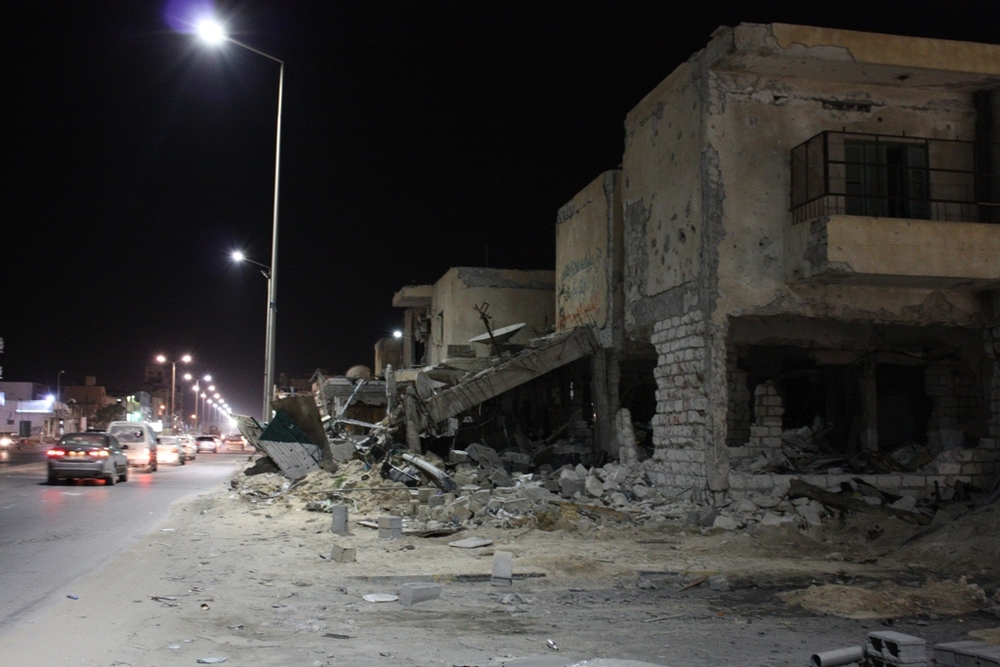 Buildings in rubble at night