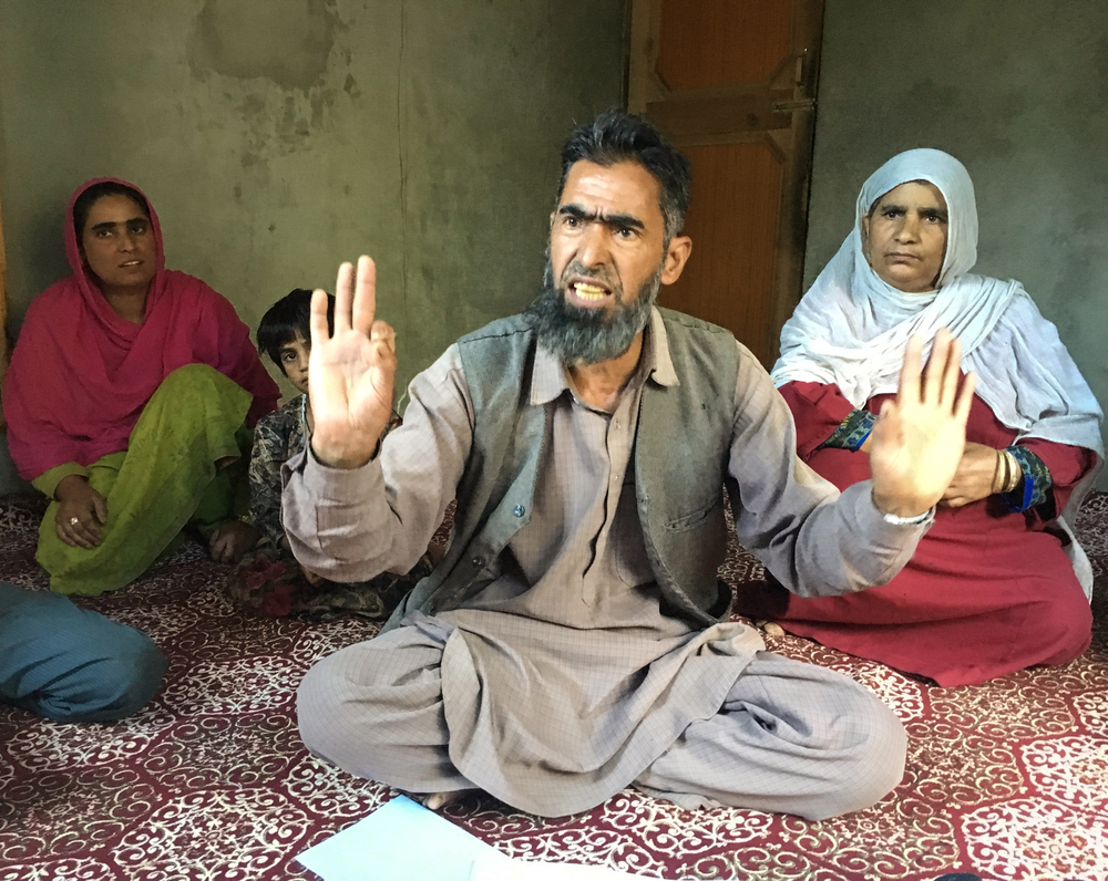 Abdul Hamid Bhat, centre, says police have detained his son since August under a state public safety law that allows detention without trial for up to two years. Shah Malla, right, says her son is not a militant.