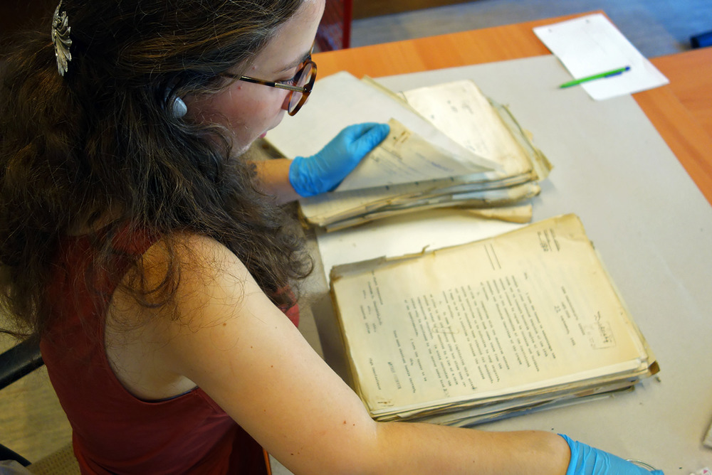 A specialist prepares documents for scanning.