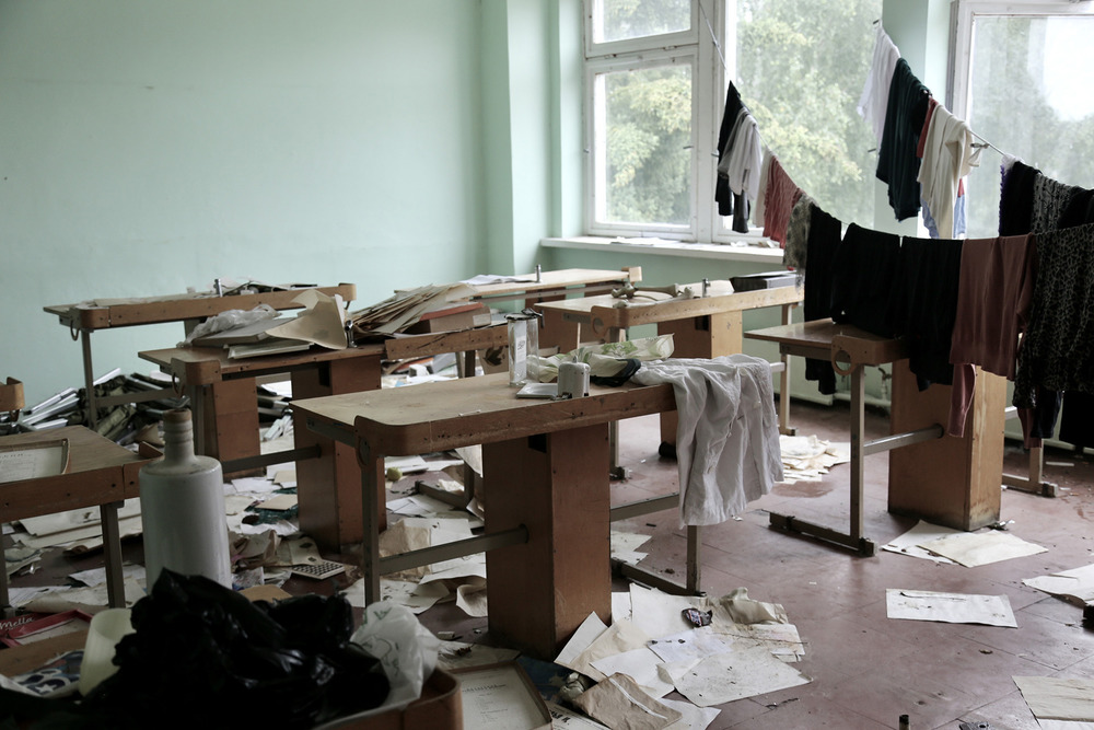 An abandoned classroom where Yazidi women sleep in the old school building turned camp for asylum seekers and migrants in Lithuania.