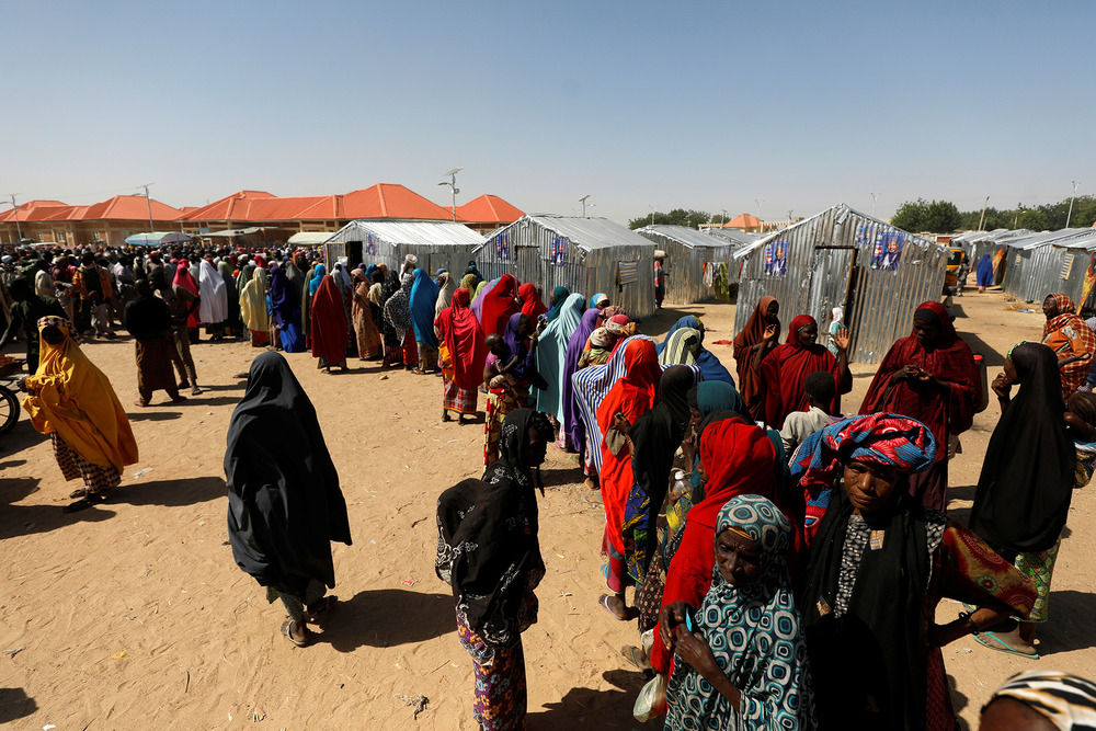 Women queue for relief at the Teachers' Village IDP camp in Maiduguri, 2019. The conflict has displaced more than two million people.