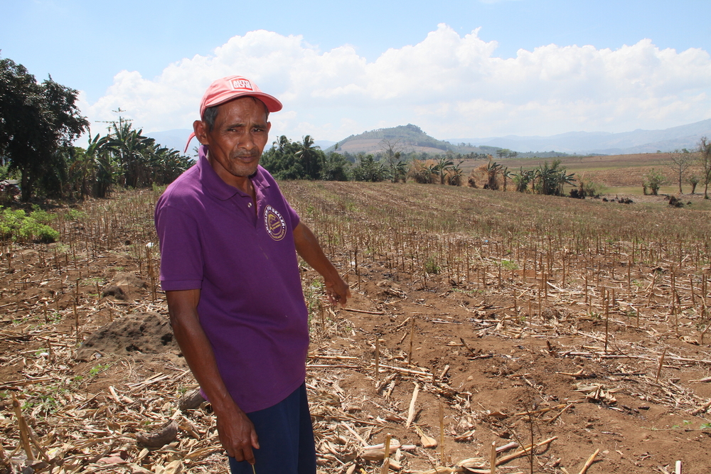 Abogantao Saiduna points to his drought-stricken corn field in North Upi, the Philippines, in February 2016