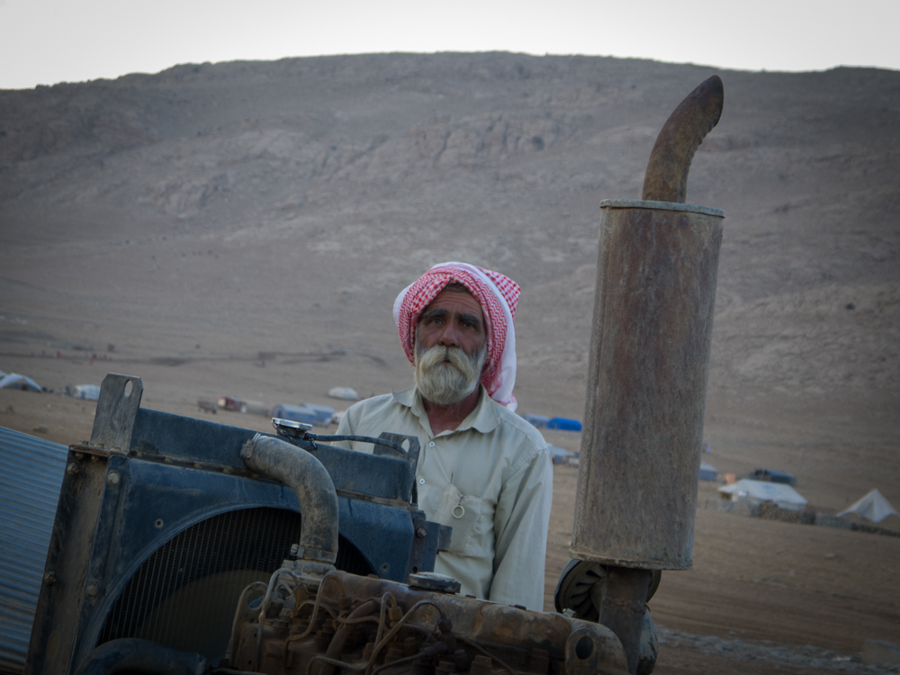A Yazidi man guards a water well on top of Mount Sinjar