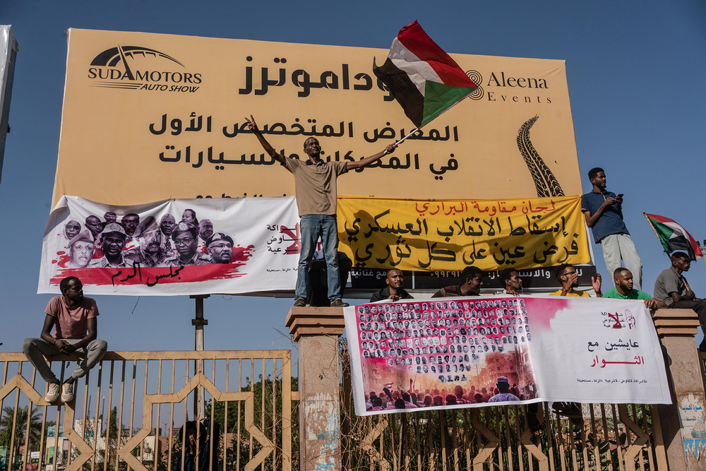 A protester holds a Sudanese flag during a march through the streets of Khartoum’s Buri neighbourhood, 17 November 2021.