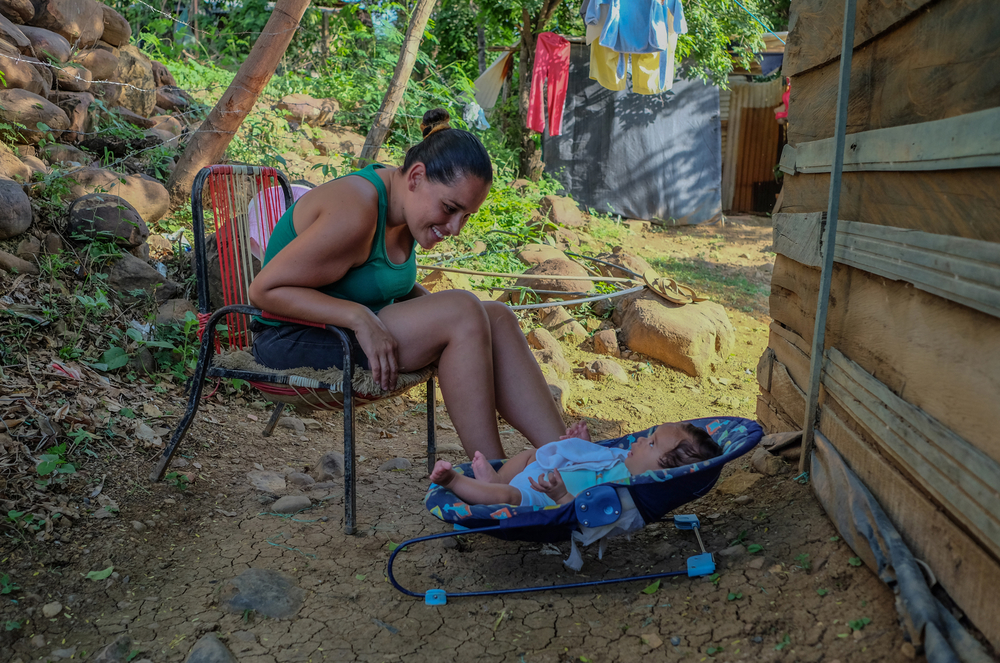Élida Betancourt and her son Christopher outside the house in Las Delicias – owned by a Colombian – where they have been living for the past nine months. They don't pay rent, only utility bills.