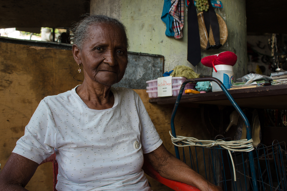 Nelina Cardalis, 78, was left behind when her family emigrated from Venezuela. She survives selling her used clothing in slums near Caracas.
