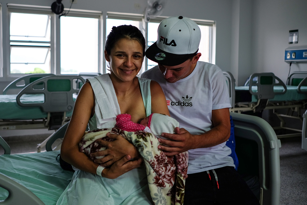 Maria Abarracin, 20, and her husband Mario Barajas hold their newborn baby Hilary at the Erasmo Meoz University Hospital in Cúcuta.