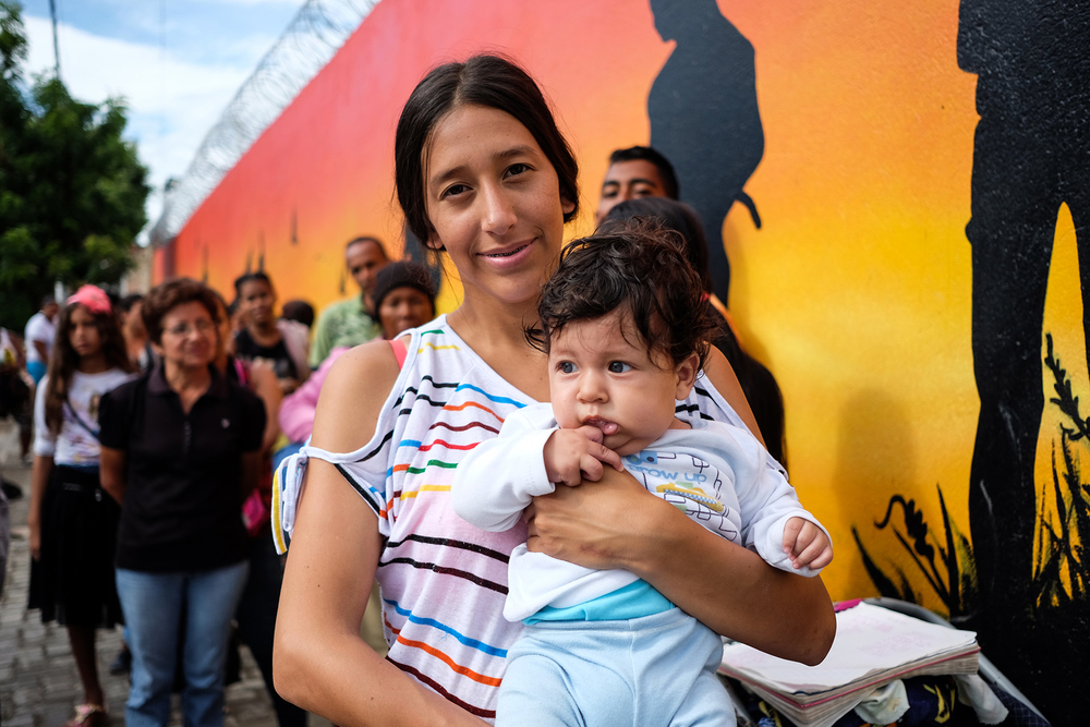 Roxana Bautista, 20, holding her six-month-old son, Keyner, at a health centre in La Parada, Cúcuta.