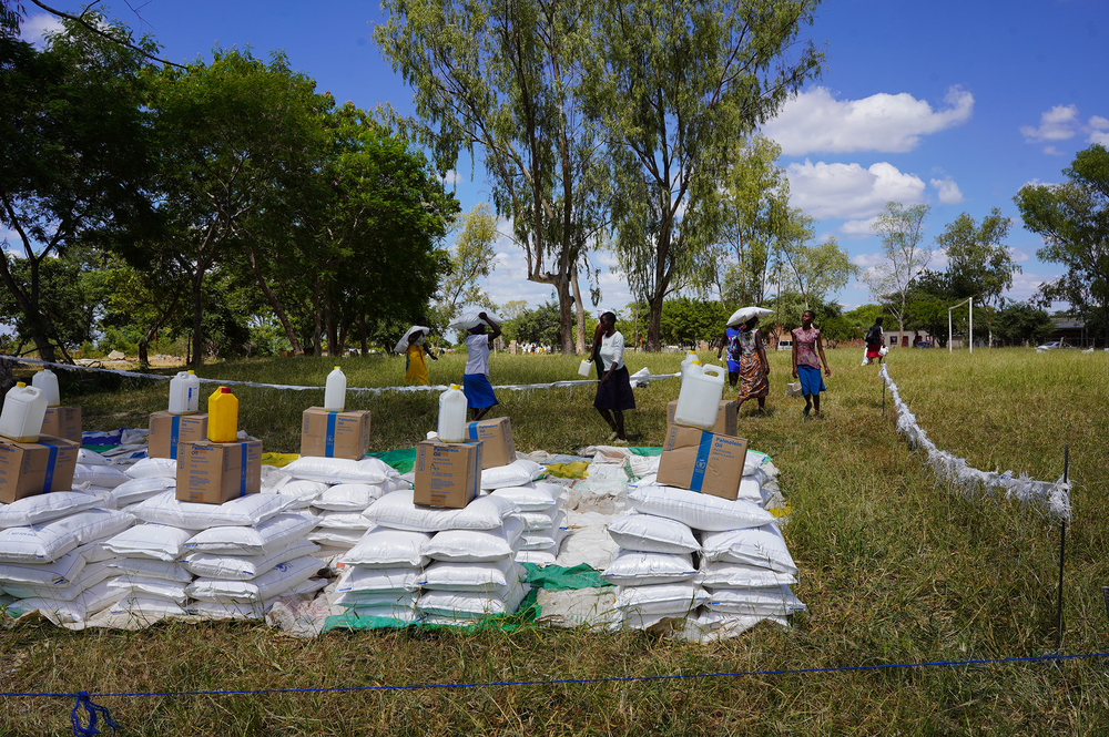 People wait in line for a WFP food distribution