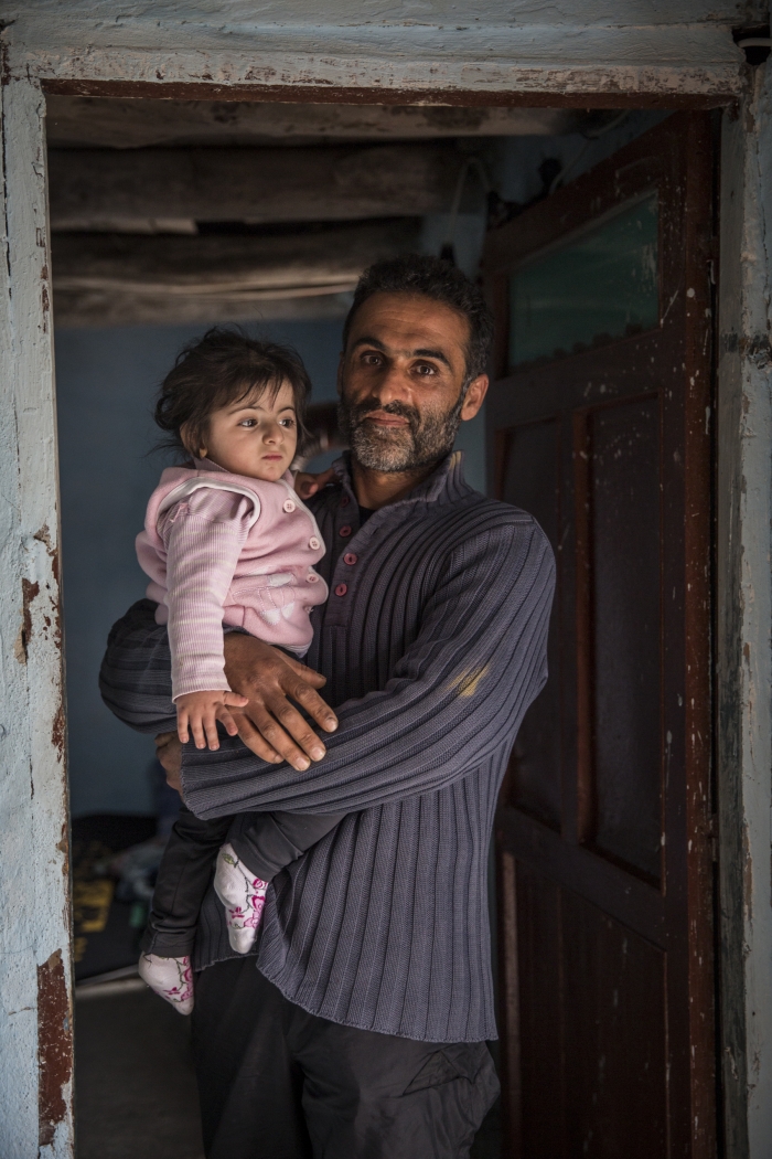 A man holds his young daughter