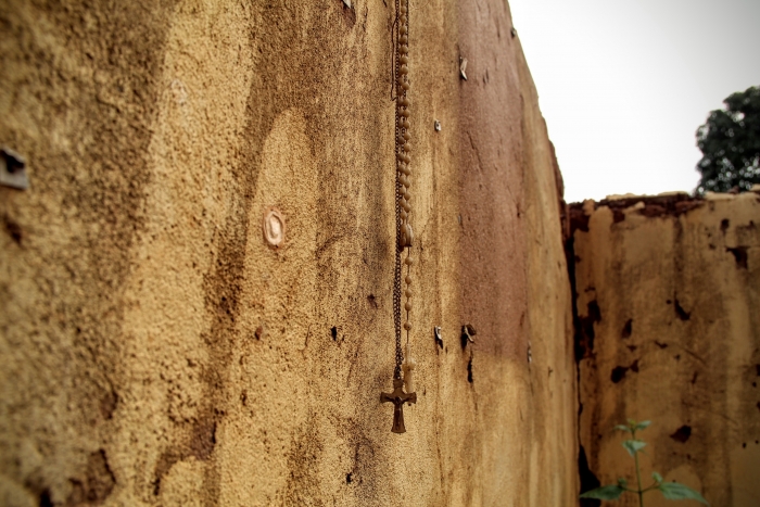 A crucifix hangs on a wall
