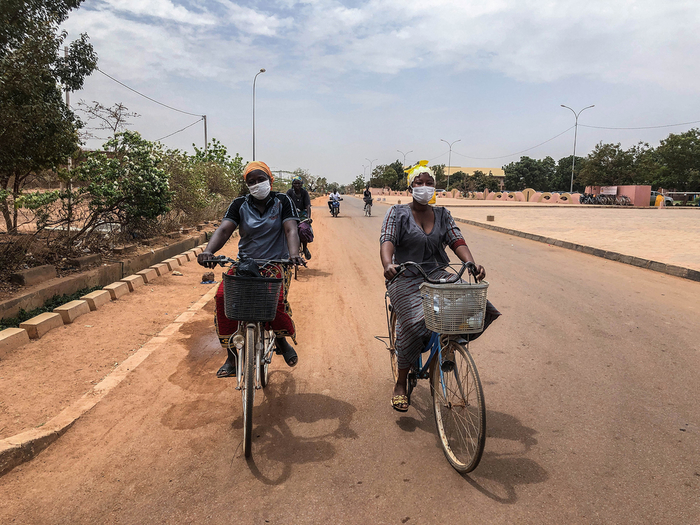 Residents protect themselves with masks while cycling in Ouagadougou