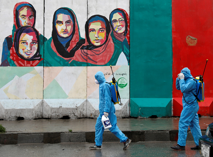 Volunteers prepare to spray disinfectant on streets in Kabul