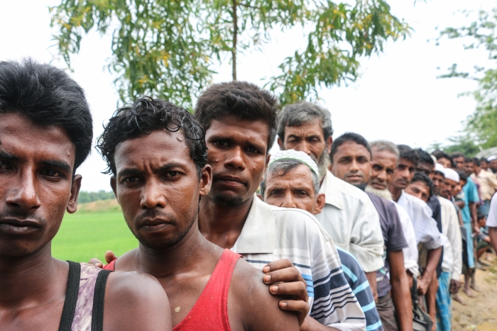 Men line up for aid distribution in Cox's Bazar, Bangladesh.