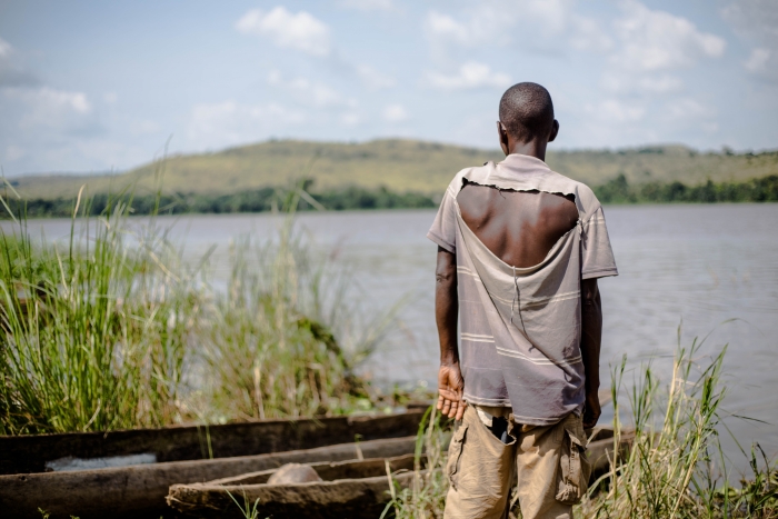 Fabrice Nzongba stares across the river to the village of Mobaye, where his son was killed