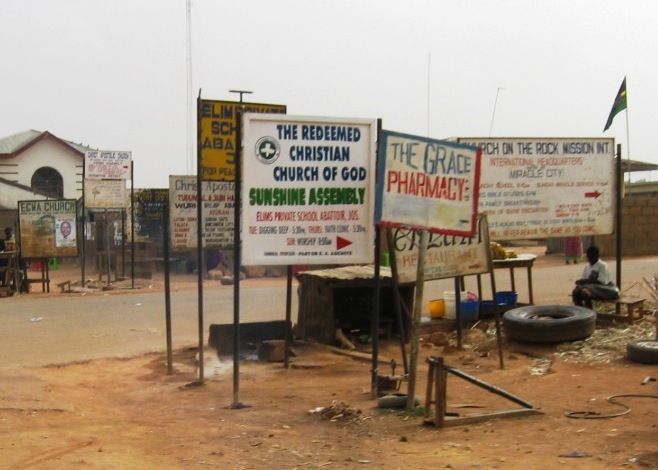 Signs pointing to the assortment of indigenous churches in Jos's Christian neighbourhoods, Jos, Nigeria, 4 April 2007. Plateau is in the so-called Middle Belt region of Nigeria, and its inhabitants are mainly Christian or animist minority groups living al
