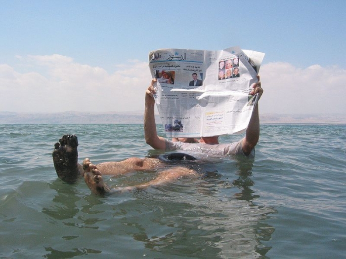 A man takes advantage of the Dead Sea’s famed high salinity. The area attracts hundreds of thousands of tourists every year