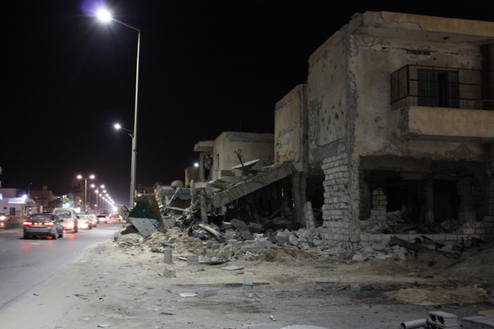 Buildings in rubble at night