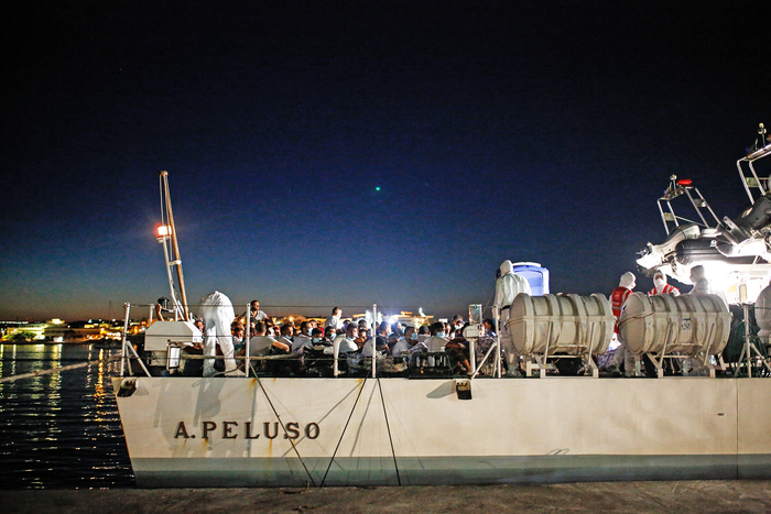 Migrants on board the coast guard ship “Peluso” wait to be transferred to Porto Empedocle, Sicily.