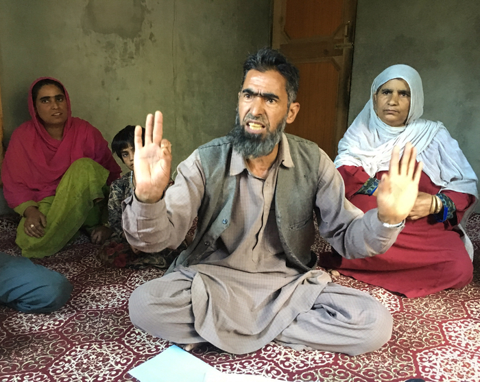 Abdul Hamid Bhat, centre, says police have detained his son since August under a state public safety law that allows detention without trial for up to two years. Shah Malla, right, says her son is not a militant.