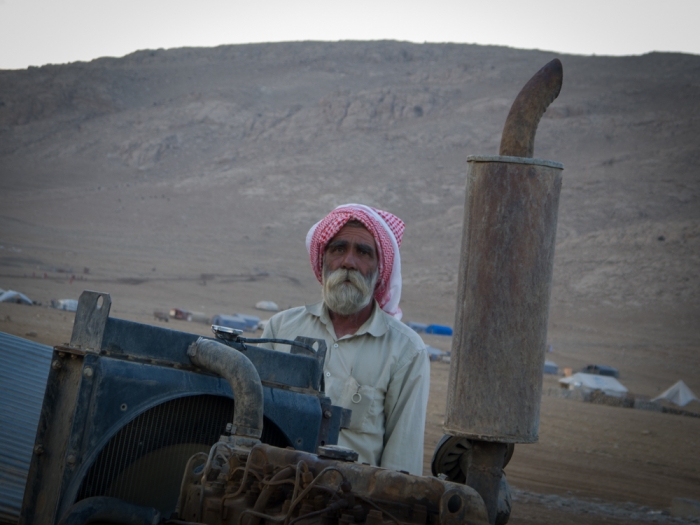 A Yazidi man guards a water well on top of Mount Sinjar