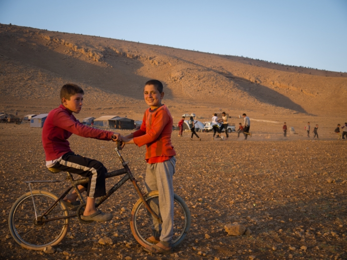 Children play on top of Mount Sinjar as the sun sets