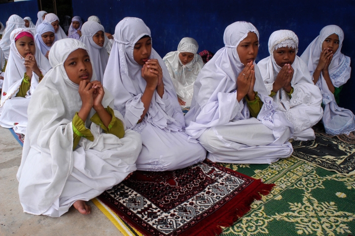 Female students from Ban Paku Village pray