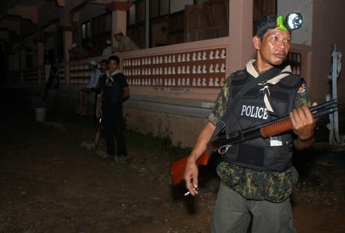 A Village Defence Volunteer guards a village mosque