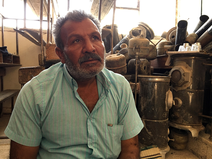 Hussein Anin and his family of six fled the violence in Ras al-Ayn, and are now sharing a classroom with several other families in a Hassakeh school.
