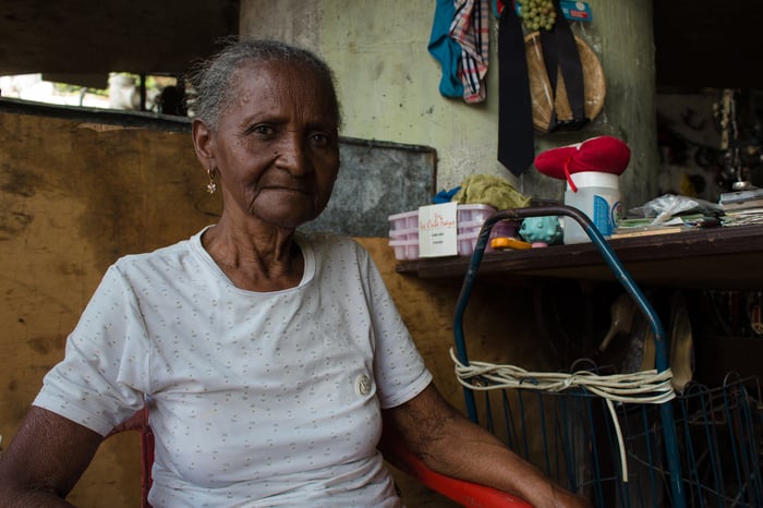 Nelina Cardalis, 78, was left behind when her family emigrated from Venezuela. She survives selling her used clothing in slums near Caracas.