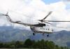 A United Nations helicopter takes off from Chautara, in Nepal's Sindhupalchok District, to transport roofing material to a remote village to rebuild homes damaged in the earthquakes of April and May 2015.